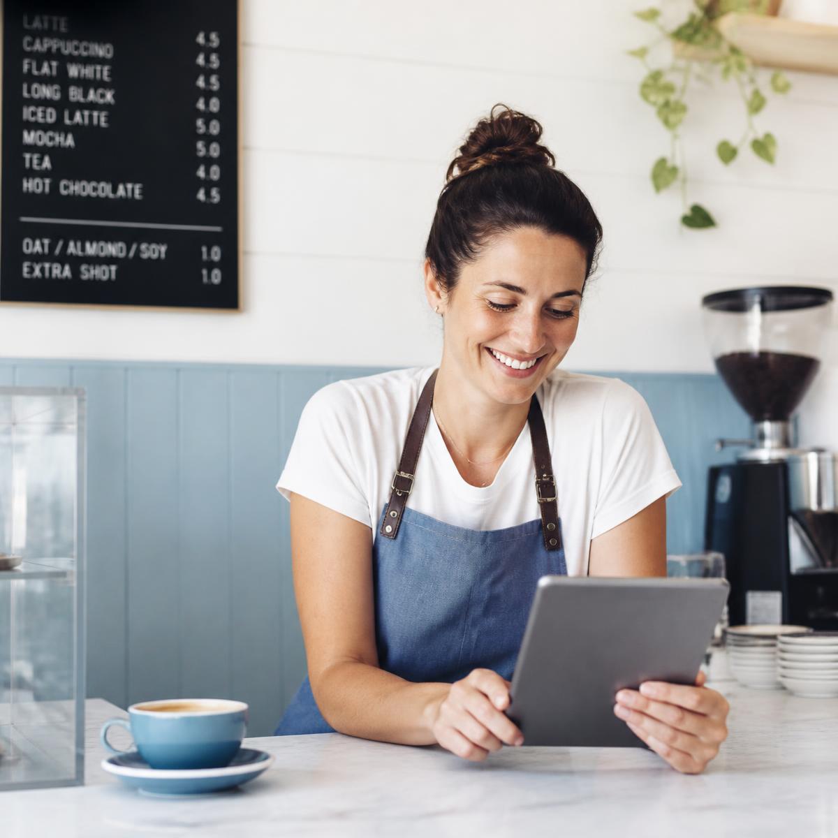Small business owner managing her online presence on a tablet